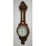 20th century oak aneroid barometer with thermometer, scroll carved case with chrome bezel,