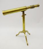 Brass table top telescope on folding tripod base,