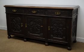 19th century carved sideboard, heavily carved, three drawers above three cupboard doors, bun feet,