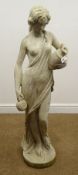 Composite garden statue of a part naked female carrying jugs, on circular base,