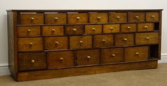 Early 20th century oak bank of twenty five drawers, W173cm, H69cm,