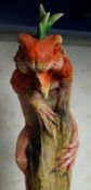 Large painted model of an Iguana naturalistically mounted on tree trunk,