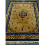 Chinese blue and salmon ground rug, central medallion, repeating border,