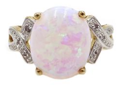 9ct gold opal ring, with diamond crossover shoulders,