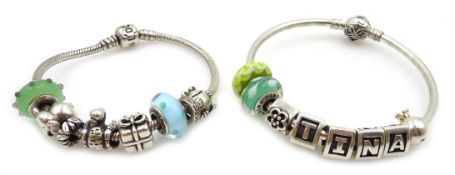 Two silver Pandora charm bracelets, each with eight Pandora charms,