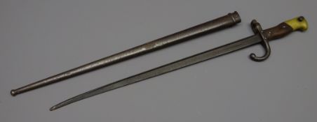 19th century French bayonet, 49cm blade indistinctly inscribed and stamped, shaped wooden handle,