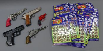 Five cap guns and approx 20 packs of ring caps