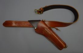 Hand made brown leather cross draw single gun rig, plain stitched belt with brass buckle,