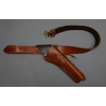 Hand made brown leather cross draw single gun rig, plain stitched belt with brass buckle,