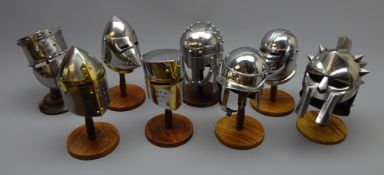 Collection of eight polished metal miniature helmets, incl.