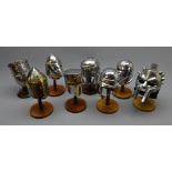 Collection of eight polished metal miniature helmets, incl.