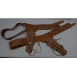 Two brown leather single gun rigs, plain stitched belts with brass buckles,