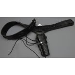 Black leather Mexican single gun rig, belt tooled with scrollwork and chrome buckle,