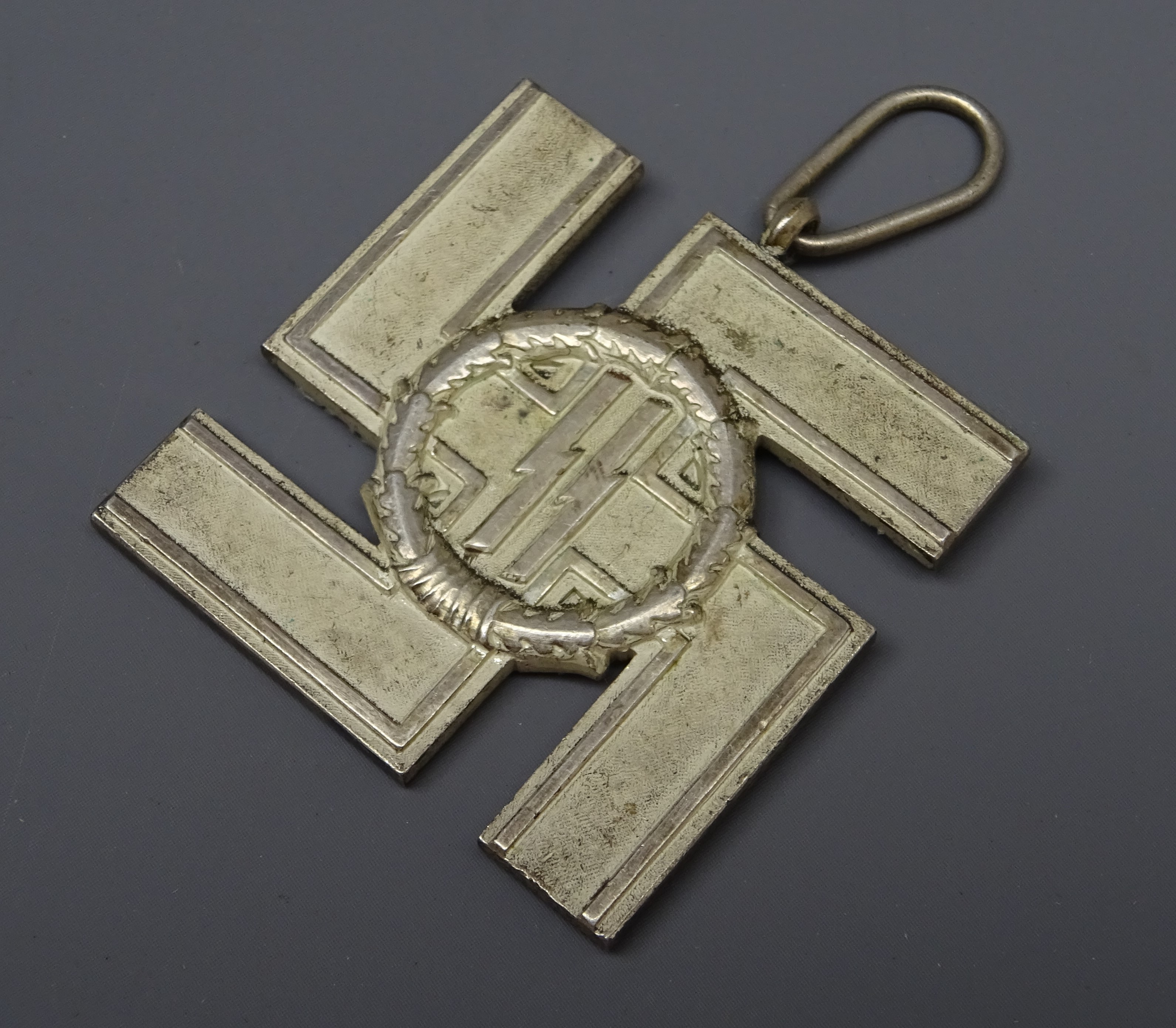 WW2 German SS 12 year Long Service Award as a silvered cross in the form of a Swastika bearing SS