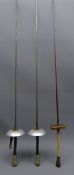 Three fencing Foils, one with pierced circular guard, blade stamped Coulaux & Co,
