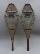 Pair of Snowshoes with traditional shaped rawhide bound bentwood frames,
