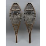 Pair of Snowshoes with traditional shaped rawhide bound bentwood frames,