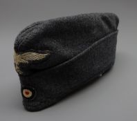 WW2 German Luftwaffe side cap, blue wool with embroidered other ranks pattern eagle and cockade,