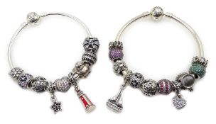 Two silver Pandora charm bracelets, one with eleven Pandora charms, the other with nine charms,