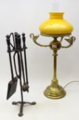 Tall eastern brass converted oil lamp, three winged swan moulded supports,