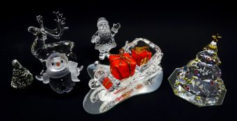 Five Swarovski Crystal Christmas figures comprising Santa Claus, Sleigh, on mirrored stand,