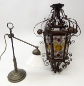 Period style adjustable patinated brass table lamp with glass shade and hexagonal cast metal