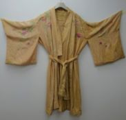 Early 20th century Japanese silk kimono, peach ground embroidered with bloomed roses,