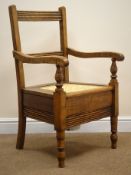 19th century country commode armchair, ladder back, daisy chain cane seat, on turned supports,