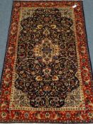 Fine Kashan red and blue ground rug, central medallion with repeating border,
