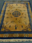 Chinese blue and salmon ground rug, central medallion, repeating border,