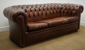 Three seat Chesterfield sofa upholstered deep buttoned brown leather, bun feet,