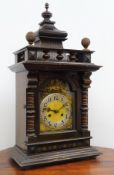Large Edwardian stained and walnut architectural cased mantel clock with arched brass Roman dial,
