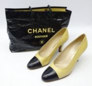 Pair of Chanel cream and black leather heeled court shoes size 39 1/2 with carrier bag