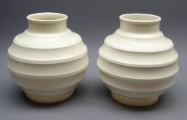 Pair of Keith Murray for Wedgwood off white Globe vases, with ribbed circular bodies,