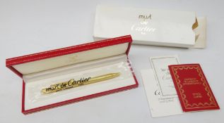 Cartier: Stylo Bille Must II ballpoint pen with reeded gold plated body, serial number 138071,