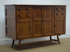 Ercol medium elm sideboard, four graduating drawers, one large cupboard flanked by two small,