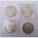 United States of America Morgan Dollars dated 1884 O mintmark and 1921 no mintmark and two Peace