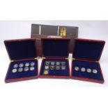 Twenty-one commemorative silver coins, in three hinged cases,