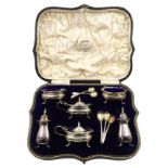 Six piece silver condiment set by Collingwood and Sons Birmingham 1915 boxed and five odd spoons