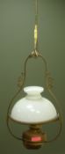 Hanging brass oil light fitting with domed white glass shade,