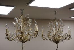 Pair of six branch French style cream metal finish chandeliers with prismatic drops,