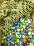 Collection of 19th century and later glass marbles including Latticinio swirls with crochet bag
