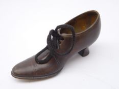 Early 20th century cast bronze model of a ladies court shoe, stamped Geschutzt,