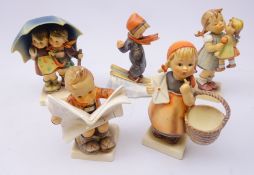 Five Goebel figures comprising 'Latest News' no. 184, 'Kiss Me' no. 311, 'Stormy Weather' no.