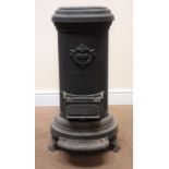 Cast iron cylindrical heating stove, top loading, lift up ashbox door,