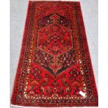Persian Hamedan red ground rug, central medallion, repeating border,