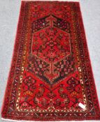 Persian Hamedan red ground rug, central medallion, repeating border,