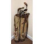 Two vintage golf bags containing various vintage clubs Condition Report <a
