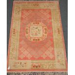 Pink ground Chinese rug, central medallion depicting two birds, repeating border (184cm x 128cm),