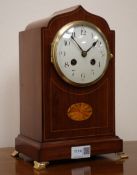 Edwardian inlaid mahogany serpentine top mantel clock with convex white Arabic dial,